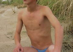 Young guy squeeze his dick and rubs it after swimming in lake